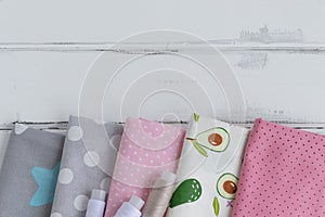 Close-up of cotton fabric. Cotton fabric laid in layers on a white background. Natural fabric for sewing clothes and bed