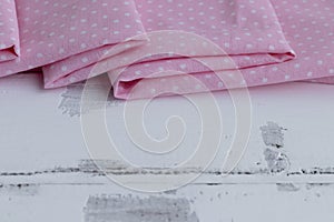 Close-up of cotton fabric. Cotton fabric laid in layers on a white background. Natural fabric for sewing clothes and bed