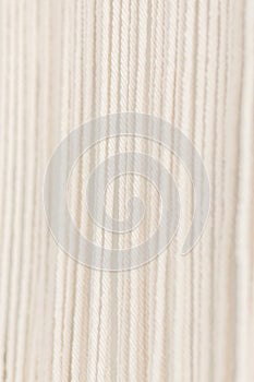 Close up of cotton macrame panel yarn in a minimalistic scandinavian wall. Texture. Background.