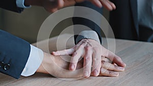 Close up couple businesspeople two multiethnic multiracial stacking their palms together. Cropped view positive