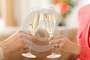 Close up of couple clinking champagne glasses