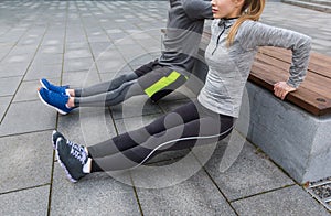 Close up of couple doing triceps dip on bench