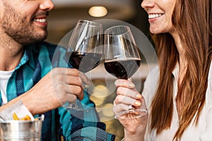 close up of couple drinking red wine at restaurant