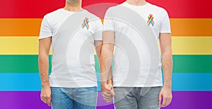 Close up of couple with gay pride rainbow ribbons