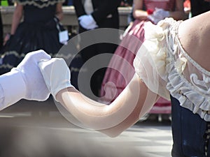 Close up of couple hands in white gloves during historical dance . Loveliness and prettiness couple of dancers photo