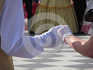 Close up of couple hands in white gloves during historical dance . Loveliness and prettiness couple of dancers photo