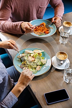 Close up of a couple having lunch over cafe table