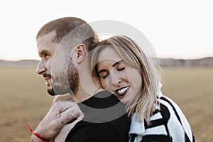 Close up couple hugging in the countryside embraced. Boyfriend and girlfriend in love