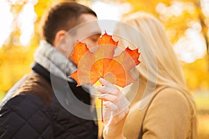 Close up of couple kissing in autumn park