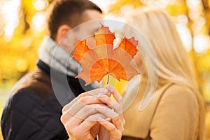 Close up of couple kissing in autumn park