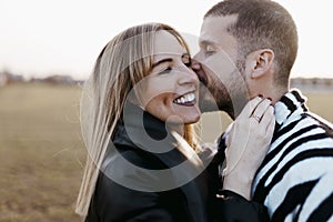 Close up couple nose kissing in the countryside embraced. Boyfriend and girlfriend in love