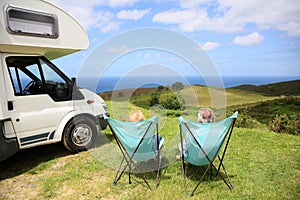 Close-up of couple relaxing on camping chairs