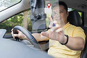 Close-up on a couple using the GPS while driving a car