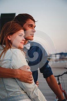 Close up of couple watching the sunrise at the beach summer time, seashore summer beach at yellow blue evening horizon sea, sunset