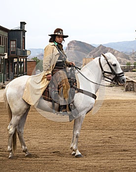 Close up of a Cowboy Riding his horse into town