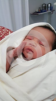 Close up of cozy Happy Healthy Indian New born baby