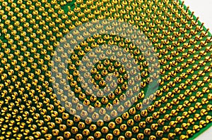 Close-up of CPU microchip gold pins, semiconductor technology background.