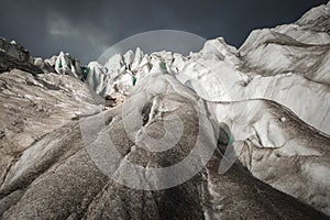 Close-up Crack is a deep blue crack found in the ice sheet and black mud on the glacier. Wide angle and dramatic sky