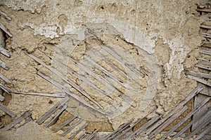 Close up of cracked adobe wall texture, clay wall from a mud house