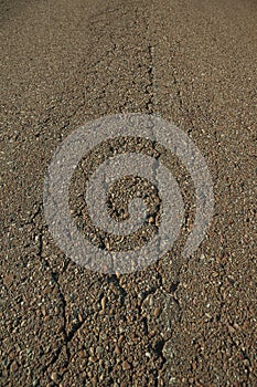 Close-up of cracked asphalt on a road