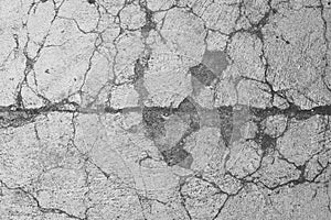 Close up of a cracked and broken concrete surface, textured background