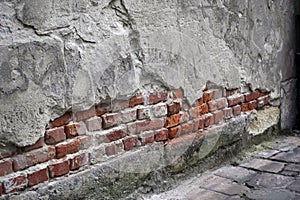 the close up cracked old building red bricks visible