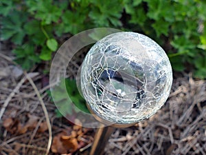 Close up of crackle glass solar led spotlight in the garden. Ene