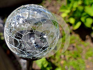 Close up of crackle glass solar led spotlight in the garden. Ene