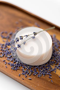 Close up of crafted lavender soap on wooden tray