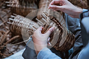 close up of craftswoman hands weaving water hyachinths making crafts