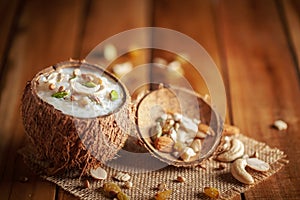 Close-up of Creamy Sabudana Kheer Garnished with dry fruits. Indian delicious dessert. Served in the coconut shell. Top View