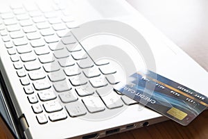 Close up credit card on laptop computer. Selective focus on keyboard. Technology, e-payment and gadget