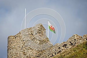 Close up of Criccieth Castle battlements with Welsh flag flying in Criccieth, Gwnydd, Wales