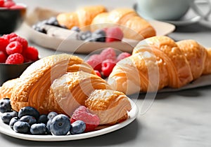 Close up croissants with berries on table