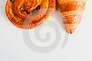 Close up on croissants, Danish pastry and chocolate and raisin filled pastries