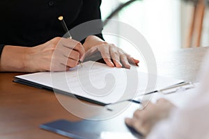 Close up cropped image young woman signing business agreement. photo