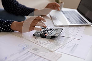 Close up cropped of Indian woman calculating and paying bills