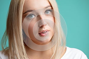 Close up cropped portrait of awasome girl with blue eyes and natural blond hair