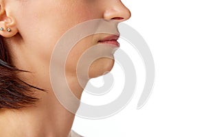 Close-up cropped profile portrait of brunette good-looking woman nose, neck, chin. Beauty anti aging procedures. Skin