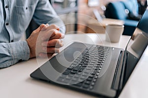 Close-up cropped shot wrinkly hands of unrecognizable nervous mature business man sitting in closed posture, tension or