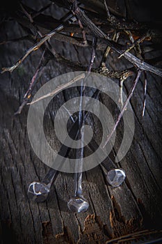 Close up crown of thorns and nails again vintage wooden background as symbol of crucifixion of Jesus Christ. Vertical image