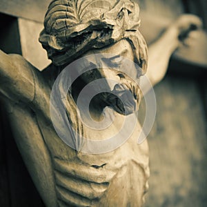 Close up crucified Jesus Christ. An ancient wooden sculpture