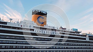 Close up for cruise ship cabins, New Zealand. Stock. Side view of a white beautiful cruise liner with passengers on