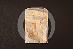 Close up crumpled paper bag isolated on black background - Vintage filter