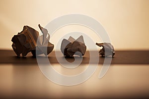 Close-up of crumpled paper ball on blurred background.