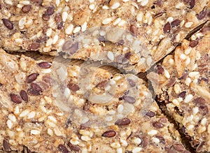 Close up of Crunchy crispy seed homemade bread. Healthy snack. multigrain cereal flax, sesame and sunflower seeds. Close up flat