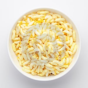 Close-Up of Crunchy Lemon Bhel in a white ceramic bowl made with Puffed Rice small besan sev. Indian spicy snacks Namkeen