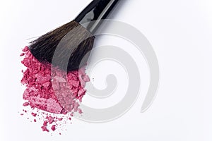 Close up of crushed blush with cosmetic brush