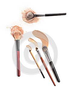 Close-up of crushed mineral shimmer powder golden color with makeup brush