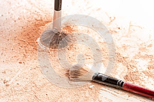 Close-up of crushed mineral shimmer powder golden color with makeup brush